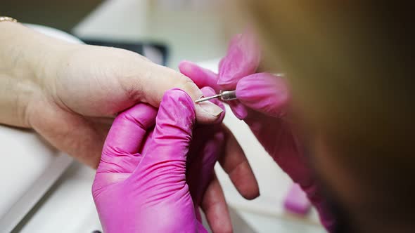 Manicure Artist Making Professional Manicure in Beauty Salon