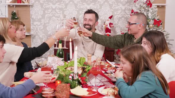 Beautiful Big Family Clinking Glasses of Champagne