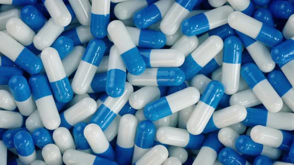 Pile Of Blue And White COVID-19 Capsules alt