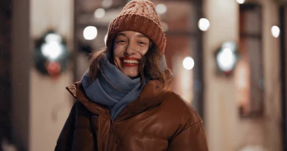 Portrait of Young Woman on the Backyard of Her House on Winter Holidays