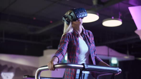 Modern Interactive Technologies Female in Glasses of Virtual Reality Playing a Arcade Game View of