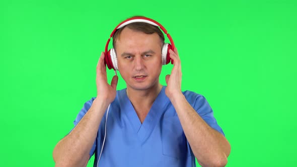 Medical Man Dancing and Singing in Big Red Headphones, Green Screen