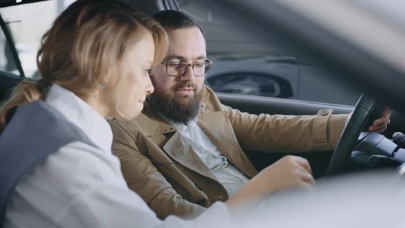 A Married Couple in the Salon of a New Car