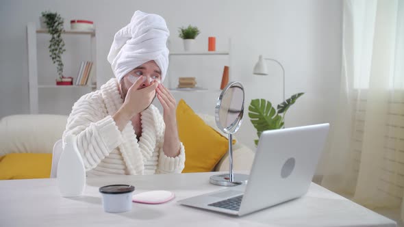 Skin Treatment and Selfcare Concept. Smiling Young Man Applying Eye Mask at Home