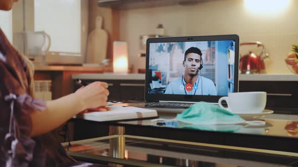 Video Call on Computer with Mixed-race Colleague at Home on Quarantine