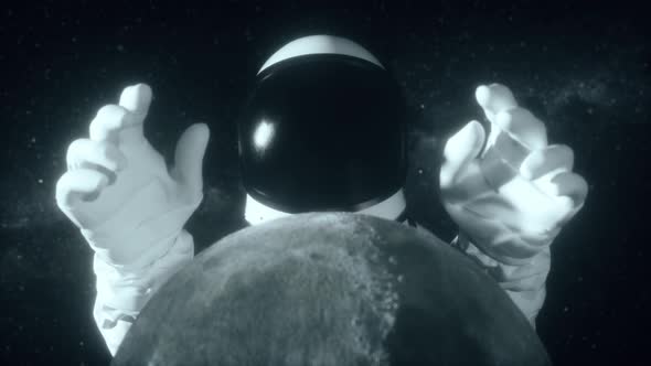 An Astronaut Stretches His Hands Behind the Moon alt