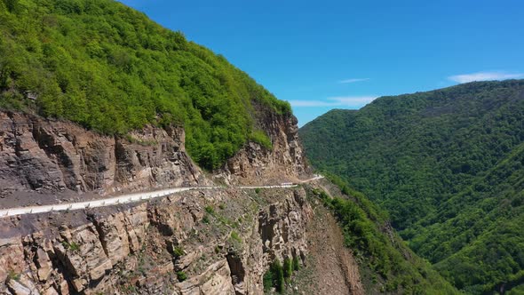 Drone Shot From Great Height of Multiple Suv Driving Through Convoluted Mountain Road in African