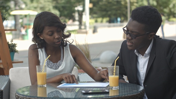 African American Business People Holding Papers Explaining