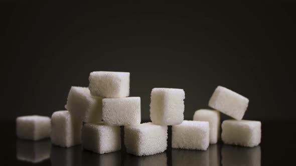 A pile of sugar pieces against black background