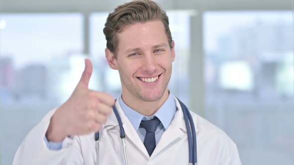 Portrait of Young Male Doctor Showing Thumbs Up in Office