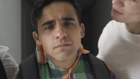 Headshot of Frightened Frustrated Bullied High School Student Crying As Classmates Shaking Him