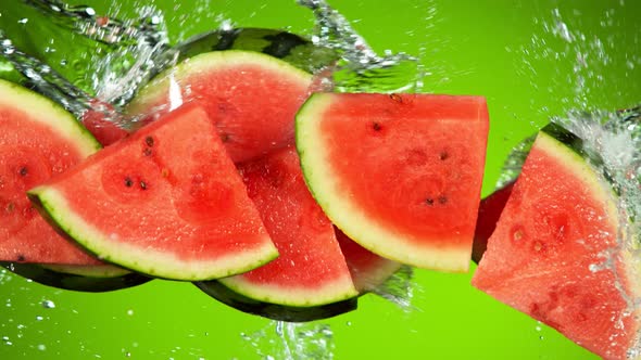 Super Slow Motion Shot of Flying Fresh Watermelon Slices and Water Side Splash at 1000Fps.