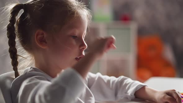 Clever Little Girl Counts Elements on Table at Mental Maths