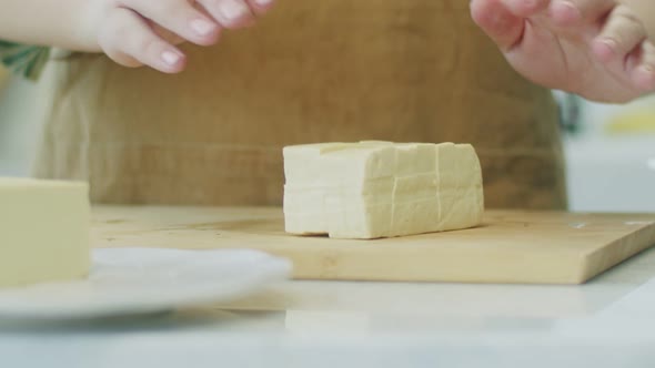 Woman preparing cheese for cooking meal