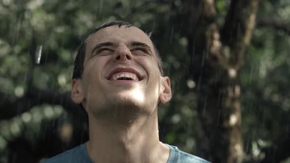 Smiling Young Man Under Rain