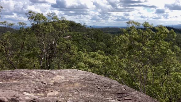 Panning left to right view from top of mountain at valleys below