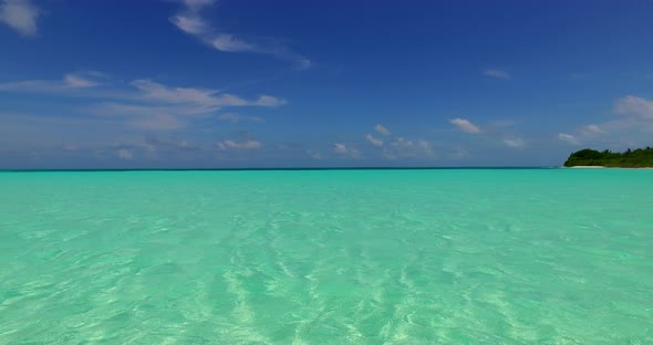 Beautiful fly over island view of a white sandy paradise beach and aqua blue ocean background in hi 