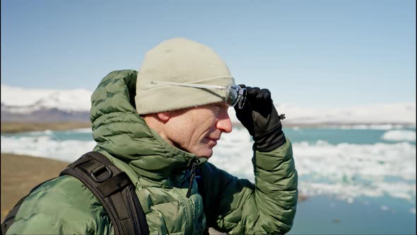 Portrait of a Man Taking Off Sunglasses in Front of Jokulsarlon Glacier Iceland