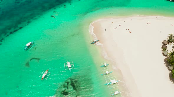 Tropical Daco Island with a Sandy Beach and Tourists