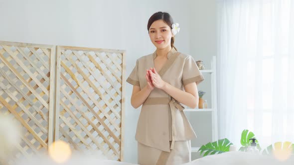 Portrait of Asian young masseuse woman smiling and looking at camera.