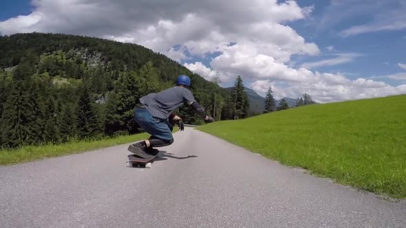 A skateboarder downhill skateboarding racing on a mountain road
