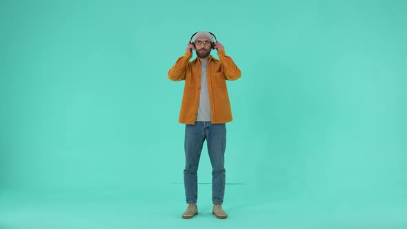 Positive Man Listening to Music in Headphones