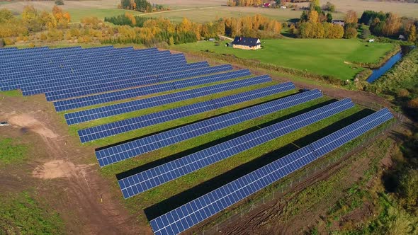 Aerial view of solar panel rows during strong sunlight, Estonia.