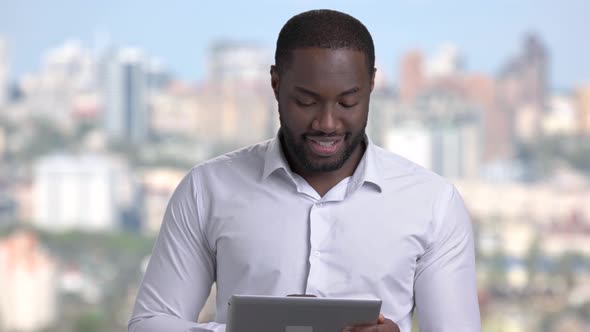 Smiling Businessman Using Digital Tablet