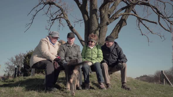 Four Seniors Calling Dog