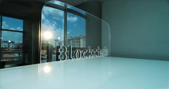 Glass Blockchain Letters and Office in Background