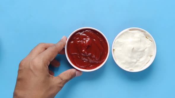 Close Up of Mustard Mayonnaise and Sauce in a Container on Table