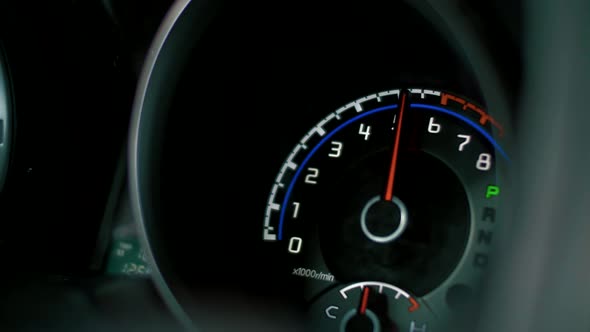 Speedometer and tachometer of a fast-moving car close-up