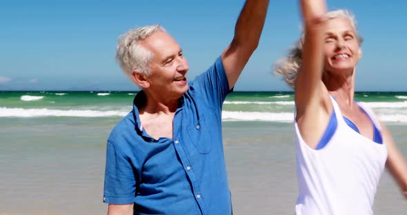 Senior couple having ice cream at the beach