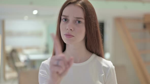 Portrait of Attractive Redhead Young Woman Saying No By Finger