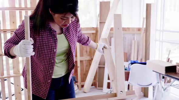 Stylish craftswoman working in carpentry. Woodwork and furniture making concept.