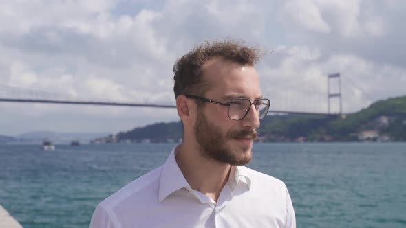 Happy and self-confident business person by the sea.