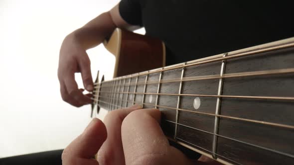 Musician Playing Acoustic Guitar on White Background