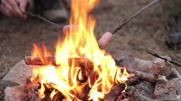 Girl is Preparing Sausages on Campfire