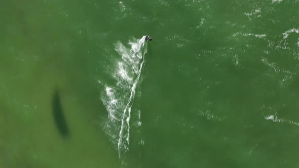 AERIAL: Top View Shot of Surfer Surfing on Extreme Speed in Baltic Sea