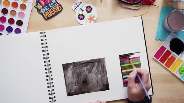 Time lapse. Step by step. Flat lay. Baker sketching a design of a cake with watercolors for Dia de l