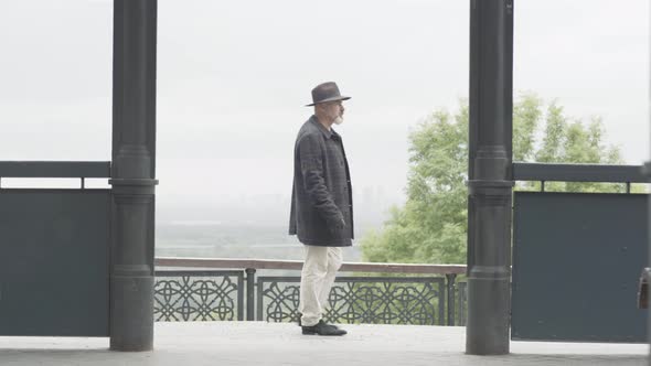 Portrait of Worried Adult Caucasian Man Walking Outdoors on Cloudy Overcast Autumn or Spring Day