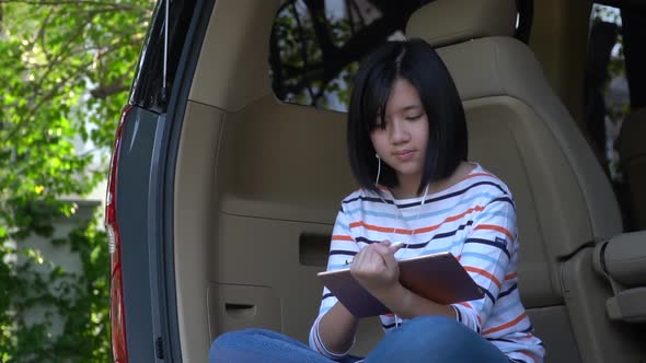 Asian Teen Using Tablet On A Car Slow Motion