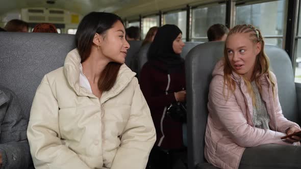 Cheerful Multiracial Girls Talking on School Bus