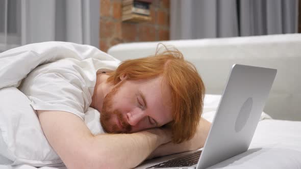 Man Sleeping While Working Laptop in Bed
