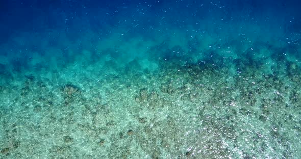 Wide angle drone abstract shot of a white sandy paradise beach and aqua turquoise water background i