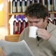 Man reading newspaper in cafe, drinking coffee - VideoHive Item for Sale