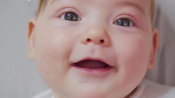 Portrait of Sweet Little Baby Girl Smiles. Closeup