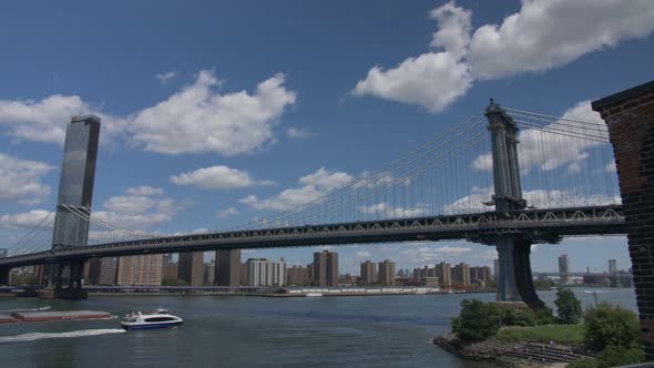 handheld panning shot of manhattan seen from brooklyn, sunny cloudy summer day