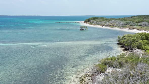 Drone flying over Caribbean waters of Isla Cabra, Montecristi in Dominican Republic. Aerial forward