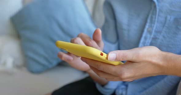 Close up of woman use of mobile phone at home